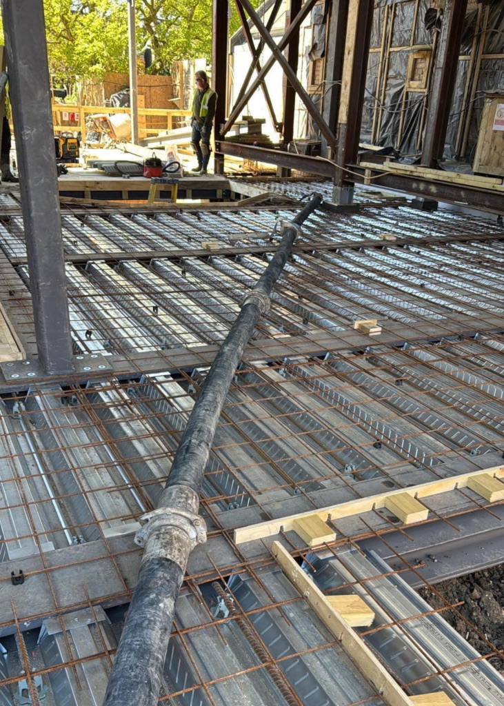 A King Concrete Pumping line pump feeding concrete on site near Reigate